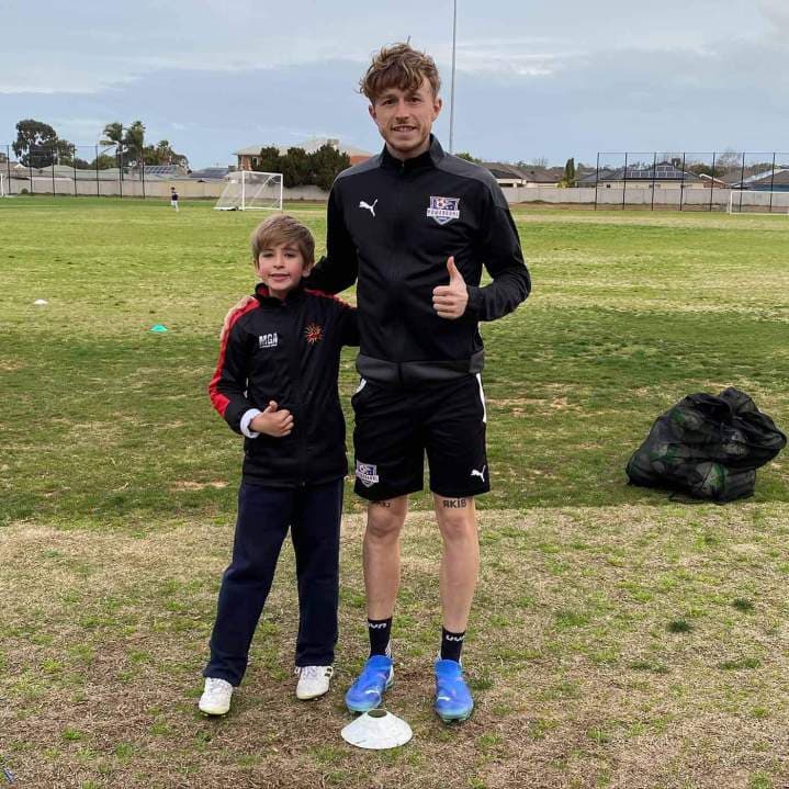 Certified football coach with a student in Melbourne